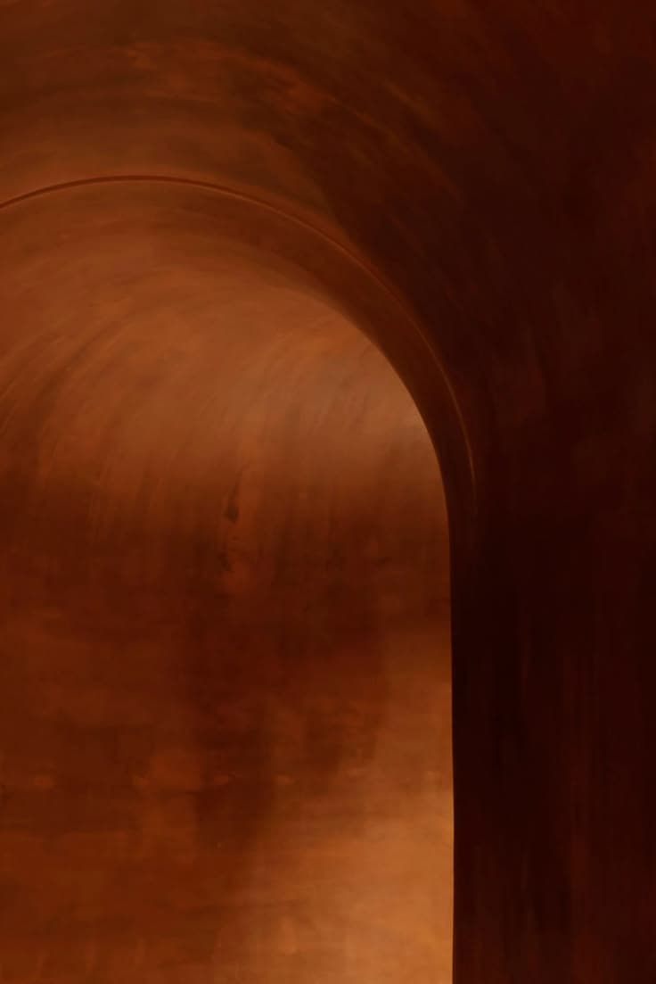 Terracotta archway leading through to the suites